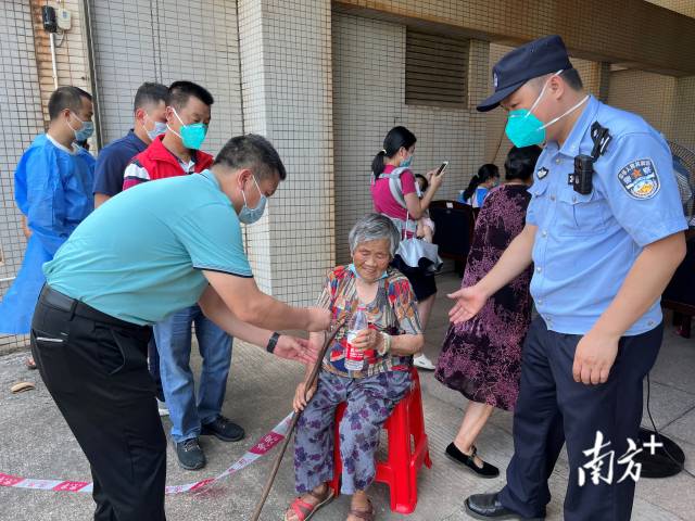 連州市委常委、副市長(zhǎng)、九陂鎮(zhèn)黨委書(shū)記綦鴻偉在核酸檢測(cè)現(xiàn)場(chǎng)協(xié)助老人參加核酸檢測(cè)，為老人做好防暑措施。